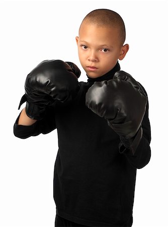 A young boy with black boxing gloves stands ready for combat. Foto de stock - Super Valor sin royalties y Suscripción, Código: 400-06092248