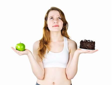 simsearch:400-05106591,k - Tempted young woman holding apple and chocolate cake making a choice Stock Photo - Budget Royalty-Free & Subscription, Code: 400-06092358