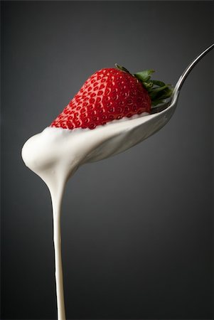 Dripping cream on a silver spoon and a strawberry Stock Photo - Budget Royalty-Free & Subscription, Code: 400-06092580