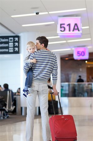 father and son waiting together at the airport Stock Photo - Budget Royalty-Free & Subscription, Code: 400-06092615