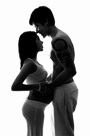 simsearch:400-05716366,k - Silhouette of pregnant lady and husband holding hands, low key. Stock Photo - Budget Royalty-Free & Subscription, Code: 400-06092802