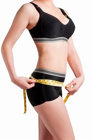 simsearch:400-04647880,k - Woman measuring her waist with a yellow measuring tape Stock Photo - Budget Royalty-Free & Subscription, Code: 400-06104061