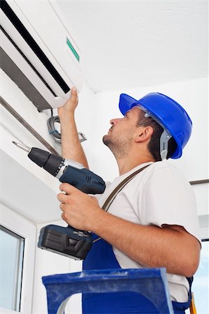 Worker installing air conditioning unit - closeup Stock Photo - Budget Royalty-Free & Subscription, Code: 400-06100781