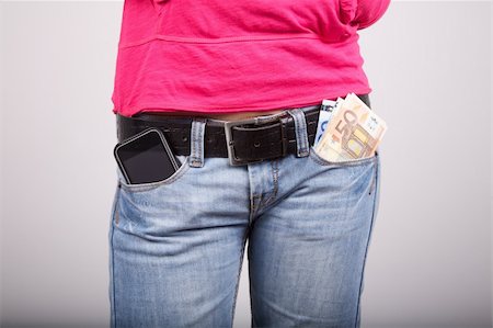 woman pink shirt detail with smartphone and money in her pocket jeans Stock Photo - Budget Royalty-Free & Subscription, Code: 400-06100884