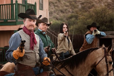 Cowgirl with three male companions in old American west scene Stock Photo - Budget Royalty-Free & Subscription, Code: 400-06101114