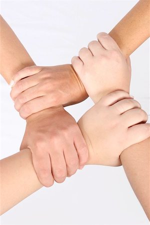 simsearch:700-00046258,k - Interlocked hands of four people Stock Photo - Budget Royalty-Free & Subscription, Code: 400-06128899