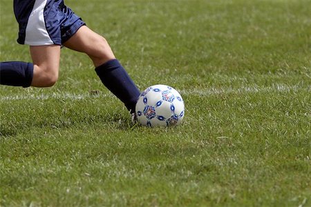 Closeup of a girl kicking a soccer ball during a soccer game. Stock Photo - Budget Royalty-Free & Subscription, Code: 400-06134049