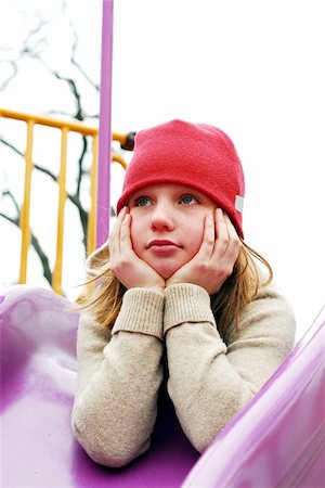 Young girl in a red hat on playground, thinking Foto de stock - Super Valor sin royalties y Suscripción, Código: 400-06134184