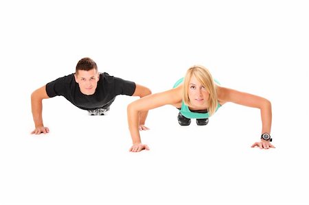A picture of a young couple doing push-ups over white background Stock Photo - Budget Royalty-Free & Subscription, Code: 400-06135543