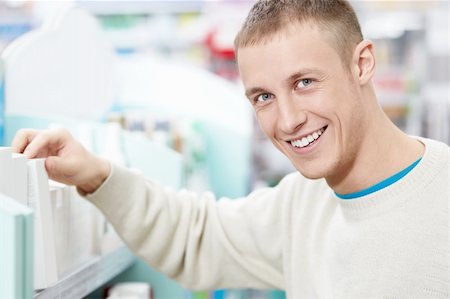 pharmacy purchase - Smiling man at the pharmacy shelves Stock Photo - Budget Royalty-Free & Subscription, Code: 400-06135929