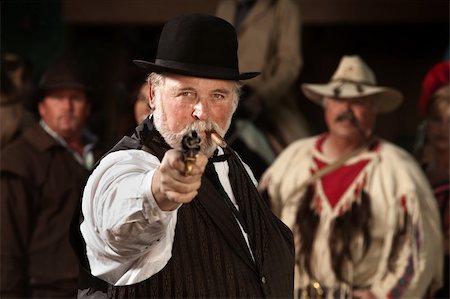 simsearch:400-06104096,k - 1800s style man in old west theme points his gun Stock Photo - Budget Royalty-Free & Subscription, Code: 400-06136101