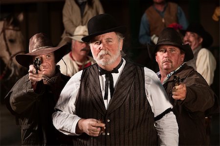 simsearch:400-06104096,k - Tough old west gambler with armed friends Stock Photo - Budget Royalty-Free & Subscription, Code: 400-06136102