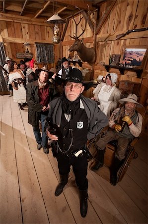 simsearch:400-06104096,k - Tough sheriff with sad customers in old American west saloon Stock Photo - Budget Royalty-Free & Subscription, Code: 400-06136540