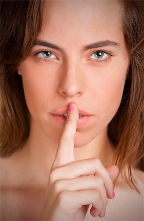 simsearch:400-04175955,k - Womanl with her finger over her mouth Stock Photo - Budget Royalty-Free & Subscription, Code: 400-06136987