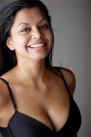 Young voluptuous Indian adult woman with long black hair wearing black lingerie and blue coloured contact lenses on a neutral grey background. Mixed ethnicity Foto de stock - Super Valor sin royalties y Suscripción, Código: 400-06137170