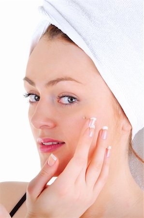 simsearch:400-06137898,k - Young woman with white tower and nice manicure is appling cream on her face, on white background Foto de stock - Super Valor sin royalties y Suscripción, Código: 400-06137896