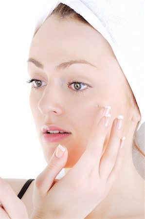 simsearch:400-06137898,k - Young woman with white tower and nice manicure is appling cream on her face, on white background Foto de stock - Super Valor sin royalties y Suscripción, Código: 400-06137899