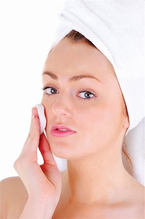 simsearch:400-06137898,k - Young woman with white tower and nice manicure is cleaning her face, on white background Foto de stock - Super Valor sin royalties y Suscripción, Código: 400-06137891