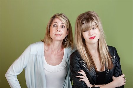 simsearch:400-05918419,k - Caucasian mother and daughter over green background making faces Stock Photo - Budget Royalty-Free & Subscription, Code: 400-06138361
