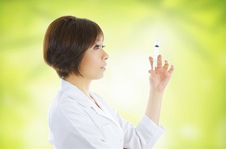 Asian beautician with syringe on green background Stock Photo - Budget Royalty-Free & Subscription, Code: 400-06139711
