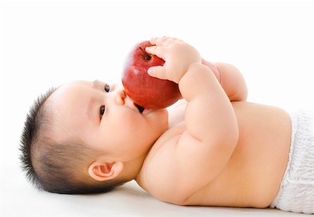 simsearch:400-07171482,k - Pan Asian baby boy eating red apple on bed Stock Photo - Budget Royalty-Free & Subscription, Code: 400-06139720