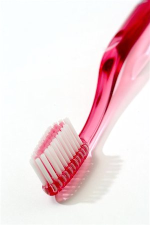 simsearch:400-04151135,k - Pink toothbrush isolated against white Stock Photo - Budget Royalty-Free & Subscription, Code: 400-06131696