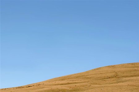 peace backdrop - Sloping hillside against a clear blue sky. Foto de stock - Super Valor sin royalties y Suscripción, Código: 400-06133557