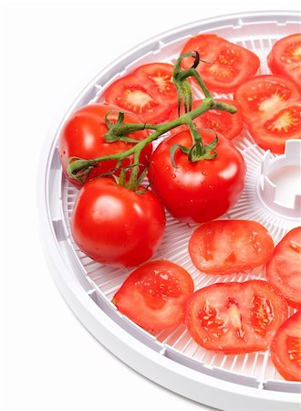 dehydrated - Fresh tomato on food dehydrator tray. Isolated on white background. Foto de stock - Super Valor sin royalties y Suscripción, Código: 400-06140261