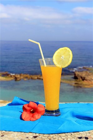 simsearch:400-05944023,k - yellow fruit cocktail on the background of a beautiful sea landscape Stock Photo - Budget Royalty-Free & Subscription, Code: 400-06142319
