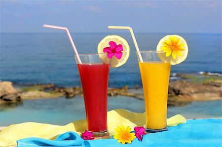 simsearch:400-05944023,k - red and yellow fruit cocktails on the background of beautiful sea landscape Stock Photo - Budget Royalty-Free & Subscription, Code: 400-06142320