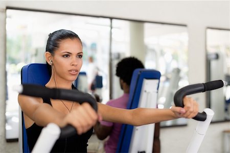 Sports activity, young man and woman exercising and working out in fitness gym Stock Photo - Budget Royalty-Free & Subscription, Code: 400-06142507