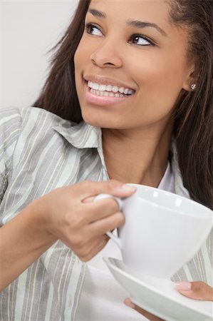 simsearch:400-06422339,k - Beautiful young African American woman or girl smiling, relaxing and drinking a cup of coffee or tea Foto de stock - Super Valor sin royalties y Suscripción, Código: 400-06142739