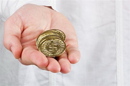 Close-up photograph of a man's hand holding a stack of coins. Foto de stock - Super Valor sin royalties y Suscripción, Código: 400-06174993