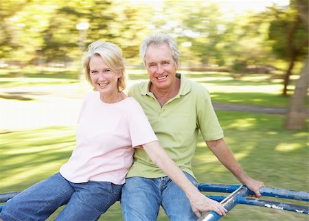 simsearch:400-04035087,k - Senior Couple Riding On Roundabout In Park Stock Photo - Budget Royalty-Free & Subscription, Code: 400-06204248