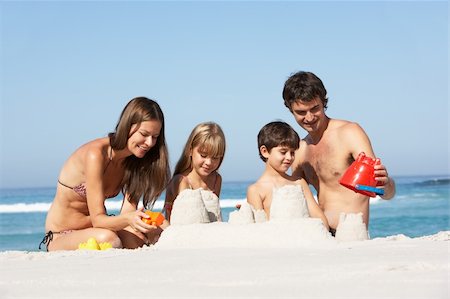 Family Building Sandcastles On Beach Holiday Stock Photo - Budget Royalty-Free & Subscription, Code: 400-06204533