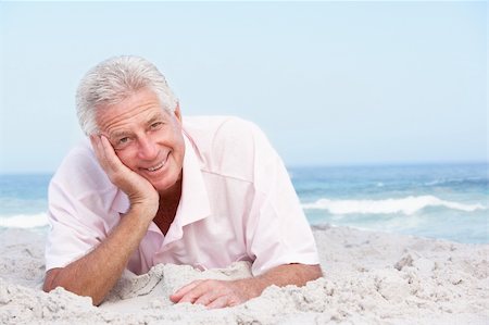 Senior Man Relaxing On Sandy Beach Stock Photo - Budget Royalty-Free & Subscription, Code: 400-06204542