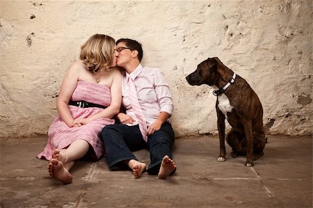 simsearch:400-06204561,k - Lesbian kissing couple on floor with pet dog watching Stock Photo - Budget Royalty-Free & Subscription, Code: 400-06204568