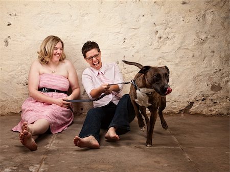 simsearch:400-06204561,k - Laughing friends sitting on the floor with funny dog Stock Photo - Budget Royalty-Free & Subscription, Code: 400-06204571