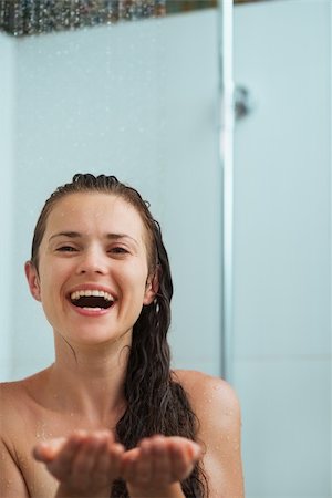 Happy woman catching water drops in shower under water jet Stock Photo - Budget Royalty-Free & Subscription, Code: 400-06207721