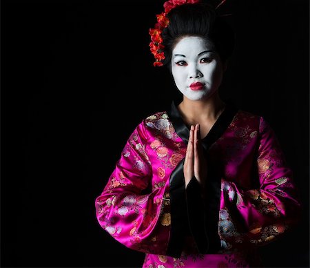 Portrait of geisha with hands together respect gesture isolated on black Stock Photo - Budget Royalty-Free & Subscription, Code: 400-06207735