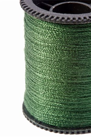 simsearch:6109-08701535,k - Close-up photograph of green thread spool on a white background. Stock Photo - Budget Royalty-Free & Subscription, Code: 400-06208196