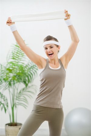 Portrait of cheerful woman in sportswear with towel Stock Photo - Budget Royalty-Free & Subscription, Code: 400-06208480