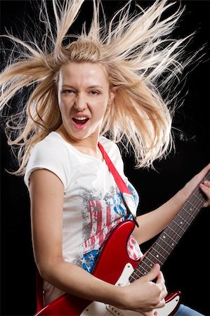 simsearch:400-04652753,k - Woman playing the electrical guitar and have fun Stock Photo - Budget Royalty-Free & Subscription, Code: 400-06202074