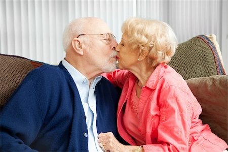 flirt senior woman - Senior couple in love, kissing on the couch. Stock Photo - Budget Royalty-Free & Subscription, Code: 400-06202511
