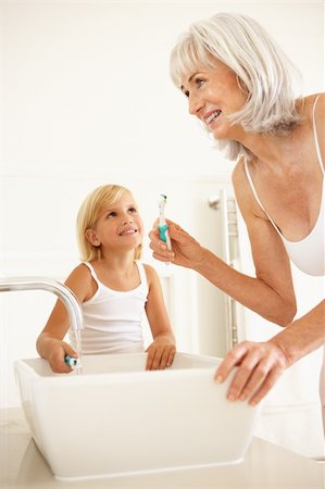 family bathroom mirror - Grandmother Brushing Teeth In Bathroom With Granddaughter Watching Stock Photo - Budget Royalty-Free & Subscription, Code: 400-06203551