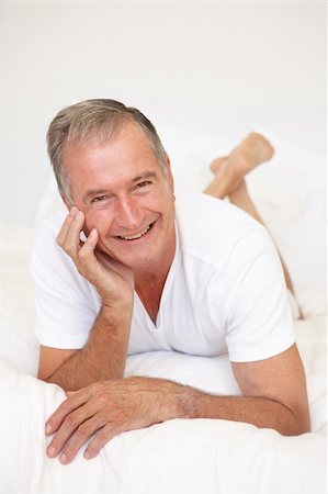 Senior Man Relaxing On Bed Stock Photo - Budget Royalty-Free & Subscription, Code: 400-06203641