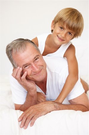 Grandfather Relaxing On Bed With Grandson Stock Photo - Budget Royalty-Free & Subscription, Code: 400-06203642