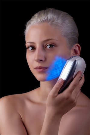 eye laser beam - Young woman getting photo-therapy treatment with blue light Stock Photo - Budget Royalty-Free & Subscription, Code: 400-06327815
