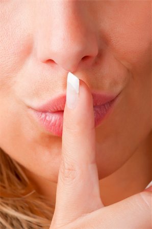 simsearch:400-04175955,k - Closeup of a woman with her finger over her mouth Stock Photo - Budget Royalty-Free & Subscription, Code: 400-06328675