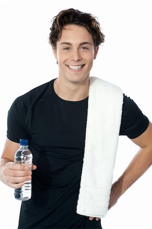 simsearch:400-06482604,k - Handsome muscular man with towel holding a bottle of water Stock Photo - Budget Royalty-Free & Subscription, Code: 400-06333936